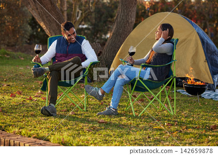 Happy, couple and wine by camping in outdoor to celebrate anniversary with love or bonding together. Smile, man and woman on adventure in nature to relax with alcohol for valentines day on vacation Happy, couple and wine by camping in outdoor to celebrate anniversary with love or bonding together. Smile, man and woman on adventure in nature to relax with alcohol for valentines day on vacation 142659878