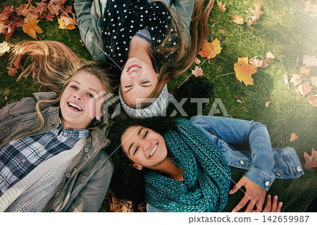 Above, teenagers or girls on park for autumn, relaxing and bonding together on grass with happiness. Nature, lawn and friends on summer holiday for chilling, hanging out and laugh outdoors with smile Above, teenagers or girls on park for autumn, relaxing and bonding together on grass with happiness. Nature, lawn and friends on summer holiday for chilling, hanging out and laugh outdoors with smile 142659987