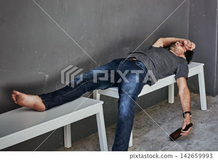 Depression, poverty and drunk man sleeping with beer on bench outdoor for addiction, disaster or mental health crisis on wall background. Homeless, stress and alcoholic unconscious in city overdose Depression, poverty and drunk man sleeping with beer on bench outdoor for addiction, disaster or mental health crisis on wall background. Homeless, stress and alcoholic unconscious in city overdose 142659993