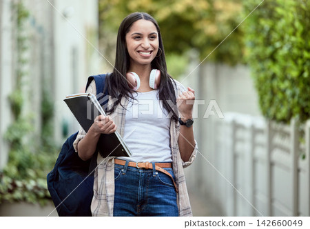Student, girl and fist pump on campus with smile, headphones and books for learning, development and study. Female person, happy and university for class, course and success in exam for education Student, girl and fist pump on campus with smile, headphones and books for learning, development and study. Female person, happy and university for class, course and success in exam for education 142660049