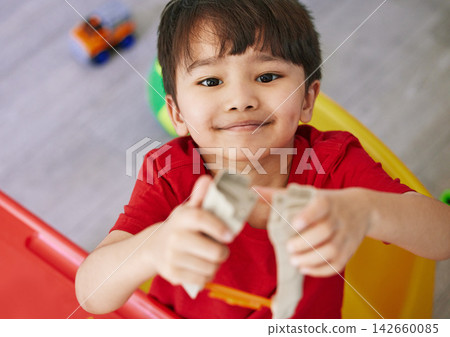 Growth, portrait and asian boy child playing with toys in bedroom of home for development from above. Face, game and smile with happy young kid in apartment for free time, learning or leisure Growth, portrait and asian boy child playing with toys in bedroom of home for development from above. Face, game and smile with happy young kid in apartment for free time, learning or leisure 142660085