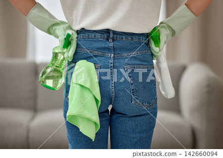 Spray, cleaning and back of person in home for hygiene, health or safety in living room. Hands, chores and maid ready with bottle for housework tools, housekeeping or cloth for maintenance service Spray, cleaning and back of person in home for hygiene, health or safety in living room. Hands, chores and maid ready with bottle for housework tools, housekeeping or cloth for maintenance service 142660094