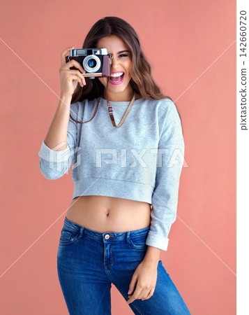 Happy, woman and camera with funny, retro lens and photography in studio with smile. Gen z, vintage and excited with photo and creative college student with photographer and laugh of cool girl Happy, woman and camera with funny, retro lens and photography in studio with smile. Gen z, vintage and excited with photo and creative college student with photographer and laugh of cool girl 142660720