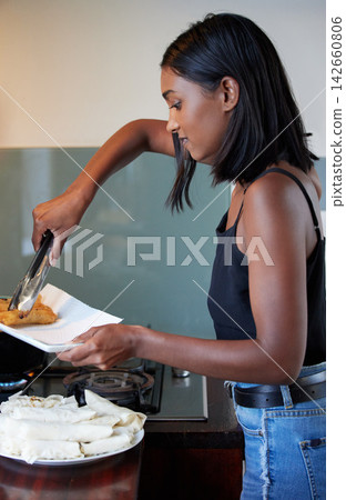 Cooking, food and woman in kitchen at apartment for Asian dinner, lunch or snack with pastry. Health, meal and female person frying crispy springroll in pan on stove for supper cuisine at home. Cooking, food and woman in kitchen at apartment for Asian dinner, lunch or snack with pastry. Health, meal and female person frying crispy springroll in pan on stove for supper cuisine at home. 142660806