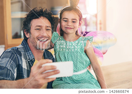 Happy father, daughter and bonding with selfie on sofa for photography, picture or memory together at home. Little girl and dad with smile or costume for capture, moment or childhood in living room Happy father, daughter and bonding with selfie on sofa for photography, picture or memory together at home. Little girl and dad with smile or costume for capture, moment or childhood in living room 142660874