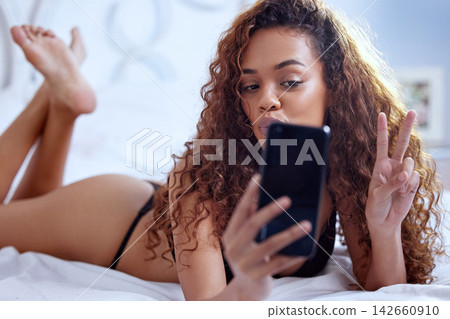 Woman, selfie and peace sign in lingerie on bed for social media, internet and underwear fashion in home. Person, style and confident for seductive picture, erotic photography and emoji in bedroom Woman, selfie and peace sign in lingerie on bed for social media, internet and underwear fashion in home. Person, style and confident for seductive picture, erotic photography and emoji in bedroom 142660910