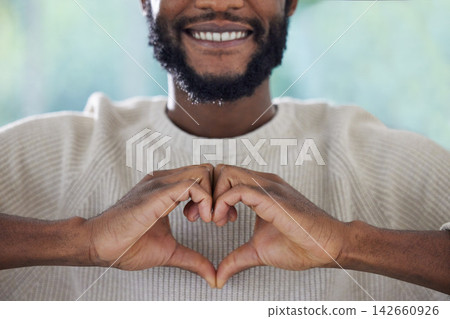 Man, heart and hands or happy with emoji for kindness, love and support with closeup in home. Person, smile and gesture for gratitude, thank you and shape for sorry or understanding in apartment Man, heart and hands or happy with emoji for kindness, love and support with closeup in home. Person, smile and gesture for gratitude, thank you and shape for sorry or understanding in apartment 142660926