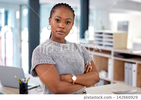 Portrait, confidence and black woman in office for business, career or pride at startup workplace. Face, arms crossed and serious African professional, creative entrepreneur and designer in Nigeria 142660929
