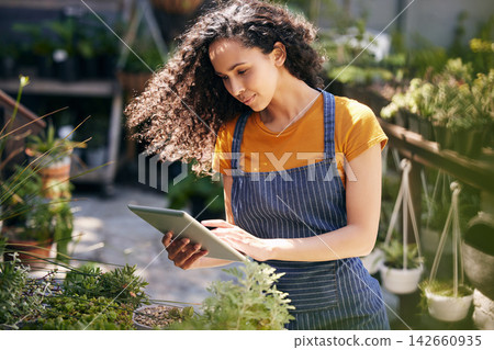 Woman, flowers and inspection with tablet for garden business, service or natural growth in nature. Female person, florist or gardener monitoring plants on technology for agriculture or conservation 142660935