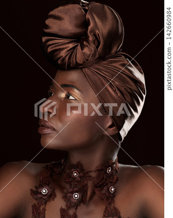 African, profile or woman with makeup, turban or necklace in studio on black background in Ghana. Skincare, face or model thinking of beauty, eyeshadow cosmetics and traditional fashion for culture African, profile or woman with makeup, turban or necklace in studio on black background in Ghana. Skincare, face or model thinking of beauty, eyeshadow cosmetics and traditional fashion for culture 142660984