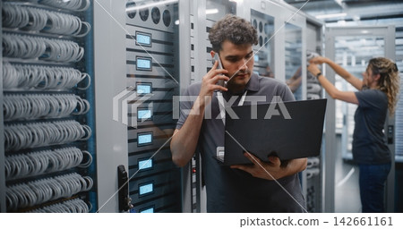 Male Data Center Engineer Reporting Server Performance by Smartphone Male Data Center Engineer Reporting Server Performance by Smartphone 142661161