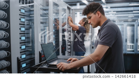 Male IT Specialist Investigating Critical Thermal Incident Through Linux Terminal in Data Center. Male IT Specialist Investigating Critical Thermal Incident Through Linux Terminal in Data Center. 142661418