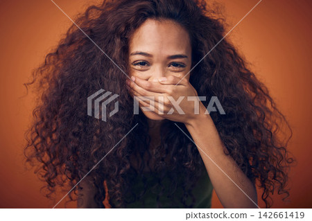 Hair, portrait and woman laughing in studio with funny, humor or joke on orange background. Haircare, beauty and model with hands on face for comic, reaction or excited for growth, shine and results Hair, portrait and woman laughing in studio with funny, humor or joke on orange background. Haircare, beauty and model with hands on face for comic, reaction or excited for growth, shine and results 142661419