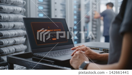 Data Center Specialist Responding to Critical Server Overheating Alert Data Center Specialist Responding to Critical Server Overheating Alert 142661441