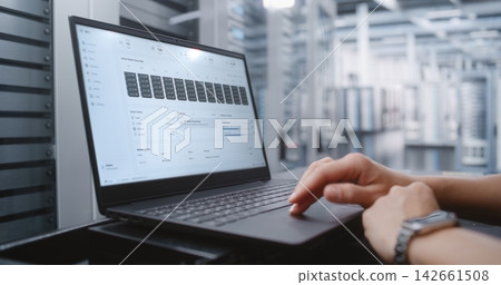 Female Network Engineer Reviewing Real Time Server Health and Data Center Infrastructure Status Female Network Engineer Reviewing Real Time Server Health and Data Center Infrastructure Status 142661508
