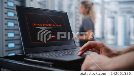 Male IT Engineer Responding to Critical Server Overheating Alert Male IT Engineer Responding to Critical Server Overheating Alert 142661526