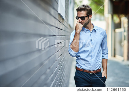 Sunglasses, fashion and man by brick wall in city with trendy, stylish and classy outfit. Accessory, handsome and male person with elegant shirt and pants for style with confidence in town street. 142661560