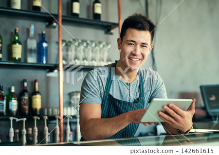 Portrait, Asian and man with tablet in restaurant as barista for online order, website and inventory for industry. Smile, Korean and male owner with digital, email and stock, sales or delivery shop 142661615
