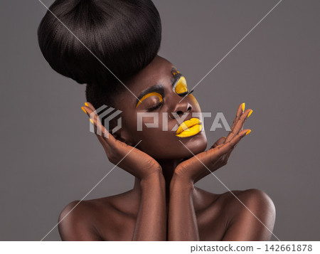 African, woman and studio art with makeup, beauty and creative yellow lipstick. Bold, model and skin with confidence, dramatic hair and bun for glamour or trendy cosmetics on isolated grey background African, woman and studio art with makeup, beauty and creative yellow lipstick. Bold, model and skin with confidence, dramatic hair and bun for glamour or trendy cosmetics on isolated grey background 142661878