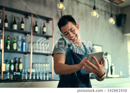 Man, phone call and waiter in restaurant talking, tablet and typing for online review and inventory order for business. Communication, planning and information search, sales and contact suppliers Man, phone call and waiter in restaurant talking, tablet and typing for online review and inventory order for business. Communication, planning and information search, sales and contact suppliers 142661938