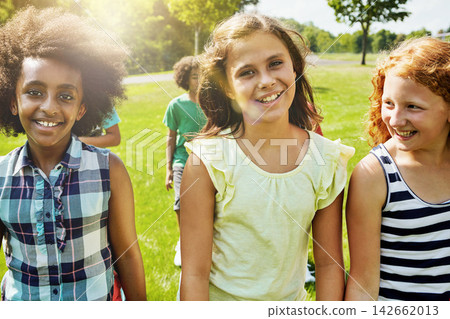 Friends, kids and playing in outdoor, happy in park, garden or development, adventure and care, bonding and party on weekend. Smile, girls and diverse with fun for childhood, youth and memory in sun 142662013