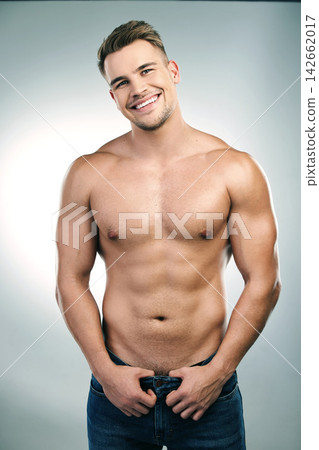 Bodybuilder, muscles and portrait of man in studio with jeans for confidence, physical training or workout results on white background. Smile, person and model body for abs, chest or transformation Bodybuilder, muscles and portrait of man in studio with jeans for confidence, physical training or workout results on white background. Smile, person and model body for abs, chest or transformation 142662017