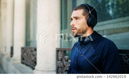Headphones, man or runner thinking in city ready to start workout, training or outdoor exercise with music. Sports podcast, audio or athlete for running for energy, wellness or fitness in England Headphones, man or runner thinking in city ready to start workout, training or outdoor exercise with music. Sports podcast, audio or athlete for running for energy, wellness or fitness in England 142662019