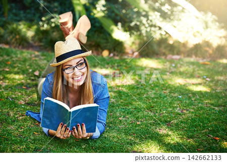 Park, thinking and girl with book for reading, learning and knowledge with smile outdoor. Nature, female student and novel for entertainment, romance and English literature for language improvement 142662133
