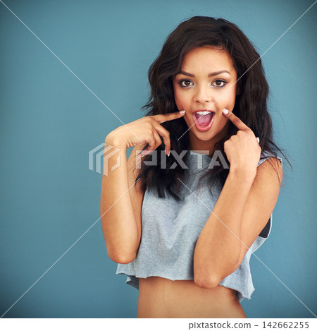 Fashion, portrait and surprise with trendy woman in studio isolated on blue background for casual style. Clothes, model and wow with cool, confident or shocked person in stylish clothing for reaction Fashion, portrait and surprise with trendy woman in studio isolated on blue background for casual style. Clothes, model and wow with cool, confident or shocked person in stylish clothing for reaction 142662255