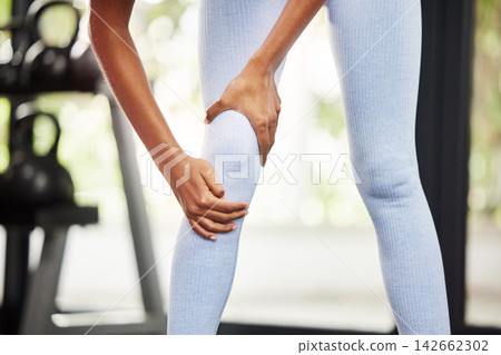 Person, pain and leg for gym fitness, exercise or injury for cardio training in outdoor activity. Female lady and active indoor for wellness, physical sport or workout for health recreation or strain Person, pain and leg for gym fitness, exercise or injury for cardio training in outdoor activity. Female lady and active indoor for wellness, physical sport or workout for health recreation or strain 142662302