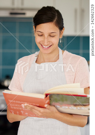 Cooking, book and woman in kitchen with recipe for meal prep for dinner, supper and lunch. Reading, vegetables and happy person with ingredients for wellness, nutrition and healthy eating in home Cooking, book and woman in kitchen with recipe for meal prep for dinner, supper and lunch. Reading, vegetables and happy person with ingredients for wellness, nutrition and healthy eating in home 142662329