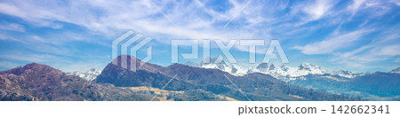 Mountain tops are covered with snow. Panorama of the mountains. National Park Peaks of Europe. Fuente De, Cantabria, Spain Mountain tops are covered with snow. Panorama of the mountains. National Park Peaks of Europe. Fuente De, Cantabria, Spain 142662341