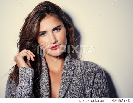 Woman, serious and portrait with fashion, boho style and clothes in studio with confidence. Cosmetics, winter outfit and modern style with cool, trendy and bohemian clothing in white background Woman, serious and portrait with fashion, boho style and clothes in studio with confidence. Cosmetics, winter outfit and modern style with cool, trendy and bohemian clothing in white background 142662588