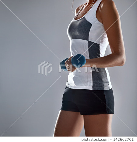 Woman, fitness and hands with dumbbell for weightlifting, exercise or workout on a gray studio background. Closeup of female person lifting weight for muscle gain, strength or bicep curl on mockup Woman, fitness and hands with dumbbell for weightlifting, exercise or workout on a gray studio background. Closeup of female person lifting weight for muscle gain, strength or bicep curl on mockup 142662701
