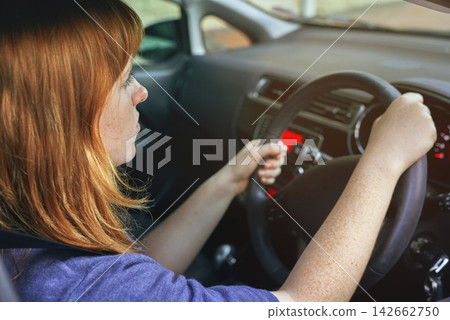 Girl, travel and drive car for transport or road trip, steering wheel and serious in morning for journey to work. Woman, vehicle and driving for transportation or commute to job, automotive and park. 142662750