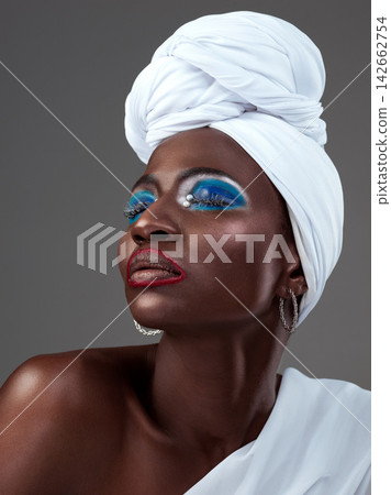African, art and creative woman with makeup and pride in beauty of indigenous culture. Studio, model and color face paint on skin with glow from cosmetics, skincare and traditional tribal style African, art and creative woman with makeup and pride in beauty of indigenous culture. Studio, model and color face paint on skin with glow from cosmetics, skincare and traditional tribal style 142662754