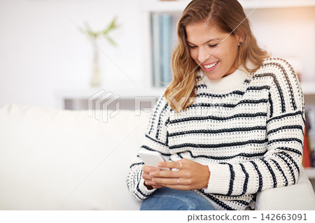 Woman, phone and texting on sofa in home with smile for notification, reading or funny meme on web. Girl, person and smartphone with mobile app, social media and streaming video on couch in lounge Woman, phone and texting on sofa in home with smile for notification, reading or funny meme on web. Girl, person and smartphone with mobile app, social media and streaming video on couch in lounge 142663091