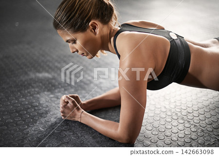 Strength, training and woman with plank in gym for balance, muscle exercise and endurance. Female person, thinking and athlete on ground in health club for fitness, core workout and challenge Strength, training and woman with plank in gym for balance, muscle exercise and endurance. Female person, thinking and athlete on ground in health club for fitness, core workout and challenge 142663098