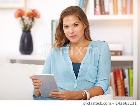 Portrait, ebook and woman relax with tablet in home on holiday or reading fantasy on vacation. Calm, girl and learning story of history, philosophy or study info online with tech in apartment Portrait, ebook and woman relax with tablet in home on holiday or reading fantasy on vacation. Calm, girl and learning story of history, philosophy or study info online with tech in apartment 142663131