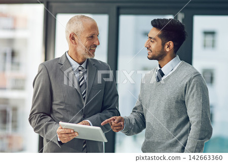 Mature man, mentor and worker on tablet with pointing in office for project, advice or business. Senior, employee and intern on technology in meeting for brainstorming, ideas and vision in corporate Mature man, mentor and worker on tablet with pointing in office for project, advice or business. Senior, employee and intern on technology in meeting for brainstorming, ideas and vision in corporate 142663360