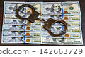 The handcuffs are on banknotes hundred dollars 142663729