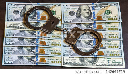 The handcuffs are on banknotes hundred dollars The handcuffs are on banknotes hundred dollars 142663729
