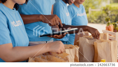 Volunteering, group of people and tablet for food donation, community service and poverty support with NGO checklist. Nonprofit manager, teamwork and groceries bag for distribution or charity project Volunteering, group of people and tablet for food donation, community service and poverty support with NGO checklist. Nonprofit manager, teamwork and groceries bag for distribution or charity project 142663736