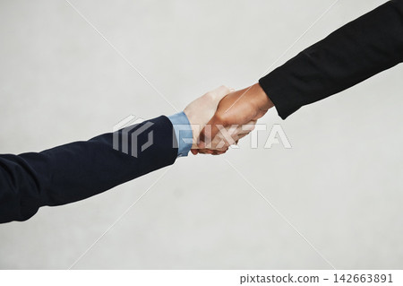 Studio, handshake and business people with agreement for teamwork, partnership and networking. B2b, deal and professional workers with thank you, welcome or support in cooperation by white background Studio, handshake and business people with agreement for teamwork, partnership and networking. B2b, deal and professional workers with thank you, welcome or support in cooperation by white background 142663891