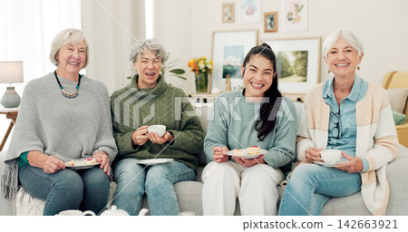 Senior women, tea and portrait of friends at a retirement home for quality time, chat or relax. Elderly people or group with a happy caregiver on a sofa for food and social visit while funny together Senior women, tea and portrait of friends at a retirement home for quality time, chat or relax. Elderly people or group with a happy caregiver on a sofa for food and social visit while funny together 142663921