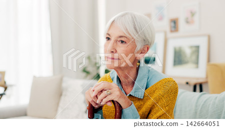 Couch, thinking and senior woman with a cane and a memory in home living room to relax on retirement. Lounge, walking stick and elderly person or pensioner with hope in a house or nursing facility Couch, thinking and senior woman with a cane and a memory in home living room to relax on retirement. Lounge, walking stick and elderly person or pensioner with hope in a house or nursing facility 142664051