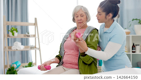 Senior woman, physiotherapy with dumbbell and nurse in clinic for rehabilitation, help and support in healthcare exercise. Physical therapy, fitness and training with a physiotherapist in hospital Senior woman, physiotherapy with dumbbell and nurse in clinic for rehabilitation, help and support in healthcare exercise. Physical therapy, fitness and training with a physiotherapist in hospital 142664150