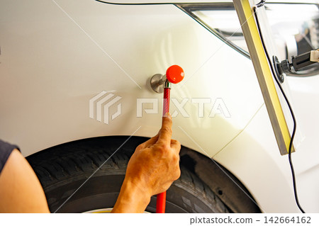 Removing dents on the car. PDR technology. Car body repair without painting. Removing dents on the car. PDR technology. Car body repair without painting. 142664162