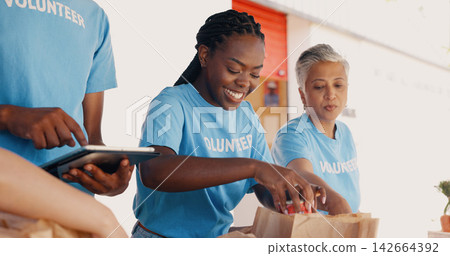 Volunteering, group of people and tablet for food donation, community service and poverty support with NGO checklist. Nonprofit manager, teamwork and groceries bag for distribution or charity project Volunteering, group of people and tablet for food donation, community service and poverty support with NGO checklist. Nonprofit manager, teamwork and groceries bag for distribution or charity project 142664392