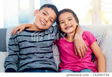 Children, hug and portrait of siblings in home, relax on sofa with care or support in happy family. Girl, brother and kids embrace with love, kindness or gratitude for friends on holiday or vacation Children, hug and portrait of siblings in home, relax on sofa with care or support in happy family. Girl, brother and kids embrace with love, kindness or gratitude for friends on holiday or vacation 142664789